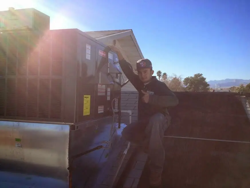 HVAC technician performing Air Duct Repair on a rooftop unit in Northchase
